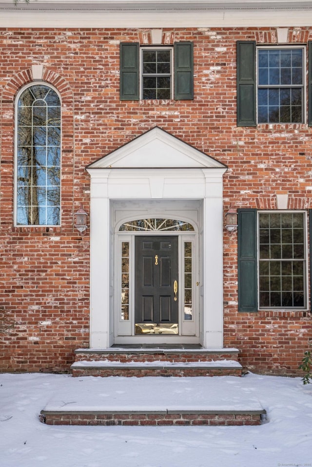 view of snow covered property entrance