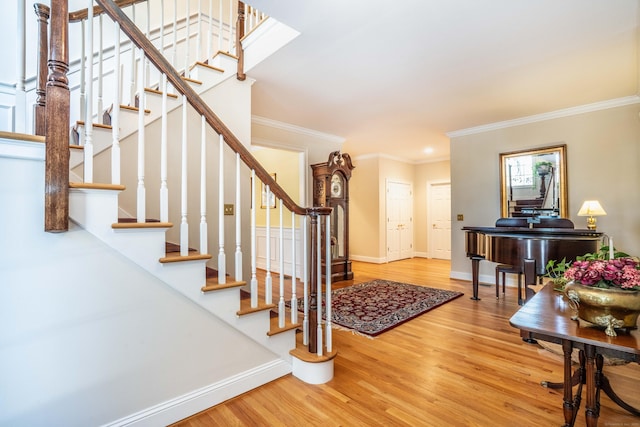 entryway featuring ornamental molding and hardwood / wood-style floors