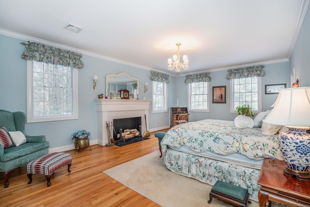 bedroom featuring hardwood / wood-style flooring, crown molding, and a notable chandelier