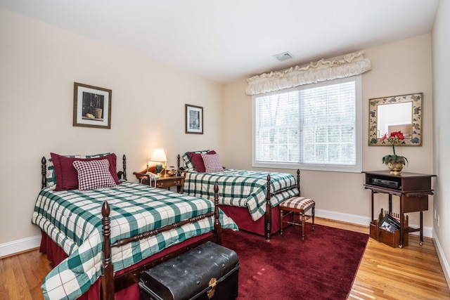 bedroom with hardwood / wood-style floors