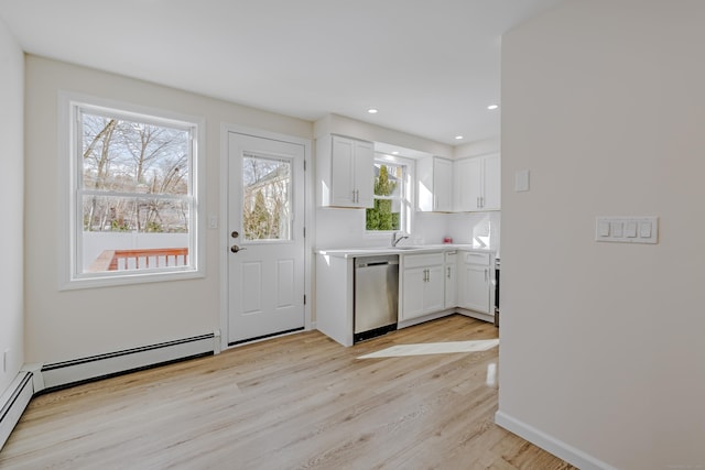 kitchen featuring sink, white cabinetry, light wood-type flooring, dishwasher, and a baseboard heating unit