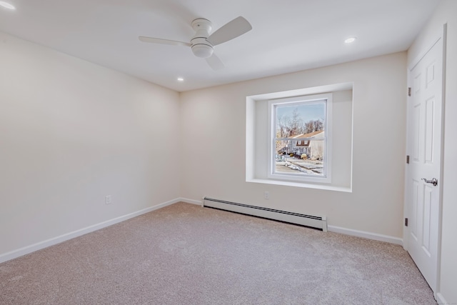 carpeted spare room with ceiling fan and a baseboard radiator