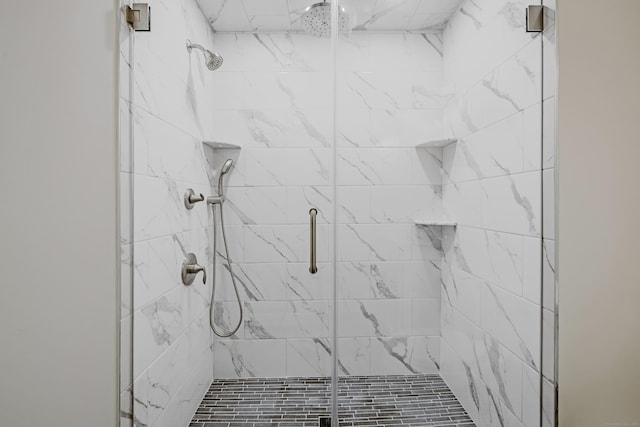 bathroom featuring a shower with shower door