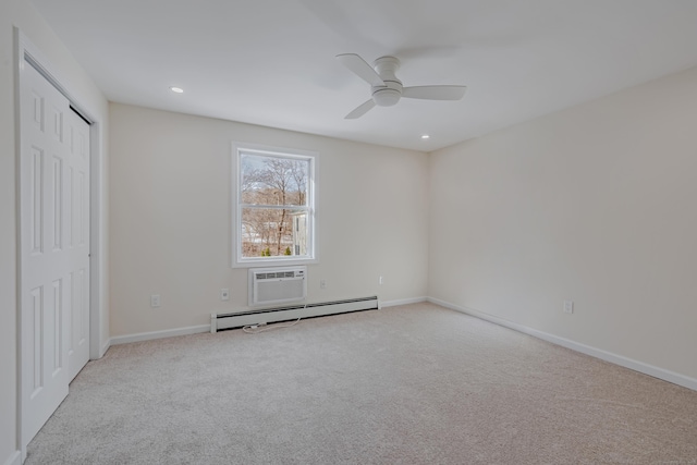 unfurnished bedroom with baseboard heating, ceiling fan, a closet, a wall unit AC, and light colored carpet