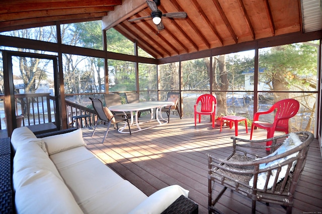 sunroom / solarium featuring vaulted ceiling with beams, a wealth of natural light, and ceiling fan