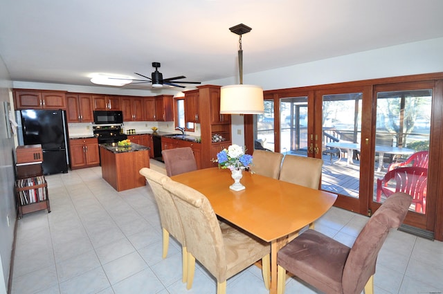 tiled dining area featuring ceiling fan