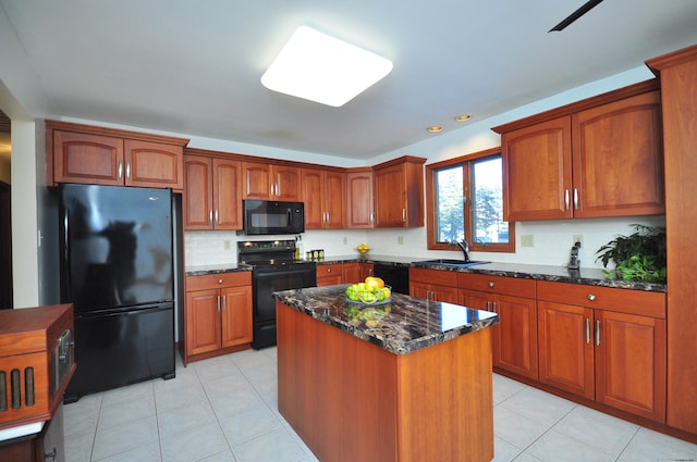 kitchen with light tile patterned flooring, sink, a center island, dark stone countertops, and black appliances