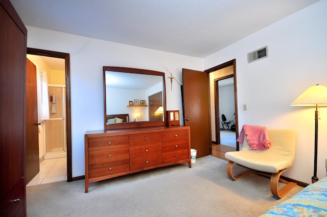 carpeted bedroom featuring ensuite bathroom