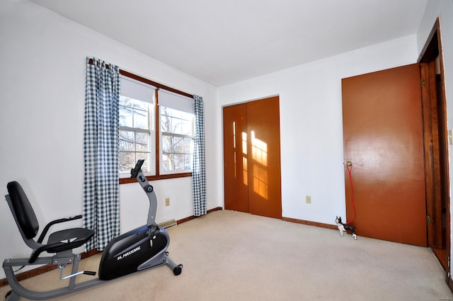 exercise area featuring light carpet