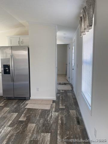 kitchen with white cabinetry, dark hardwood / wood-style floors, and stainless steel fridge with ice dispenser