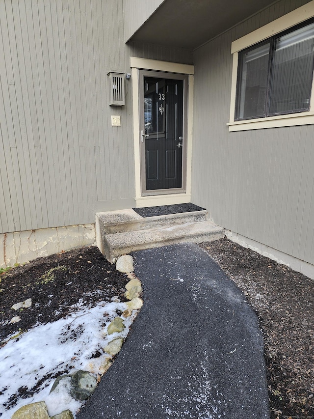 view of snow covered property entrance