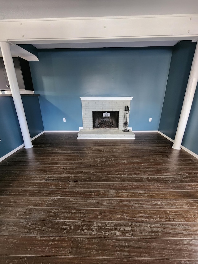 unfurnished living room featuring hardwood / wood-style flooring and a fireplace