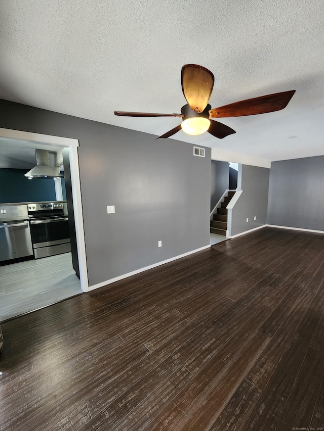 unfurnished living room with ceiling fan, wood-type flooring, and a textured ceiling