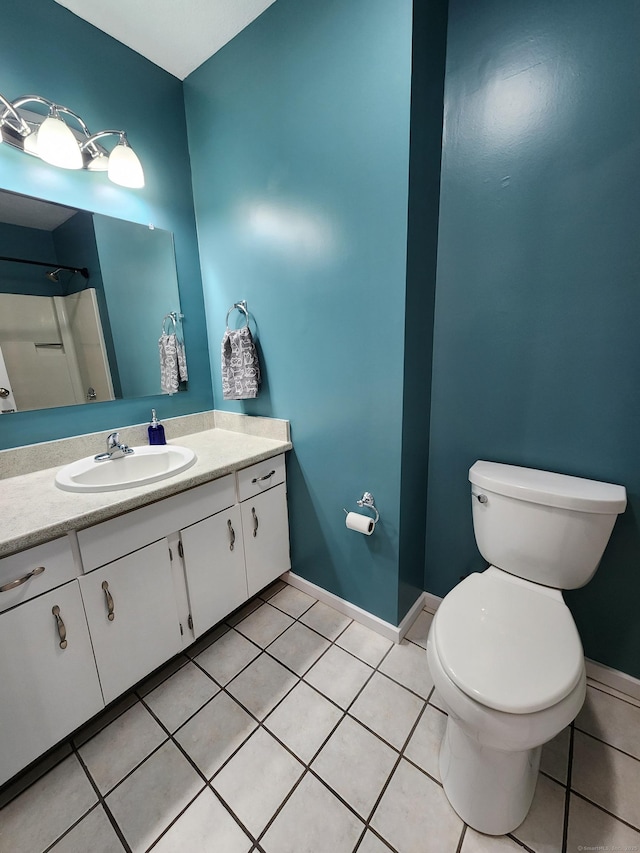 bathroom with tile patterned floors, toilet, vanity, and a shower