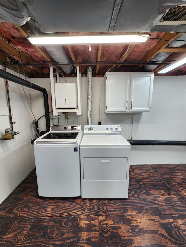 laundry area with cabinets and washing machine and dryer