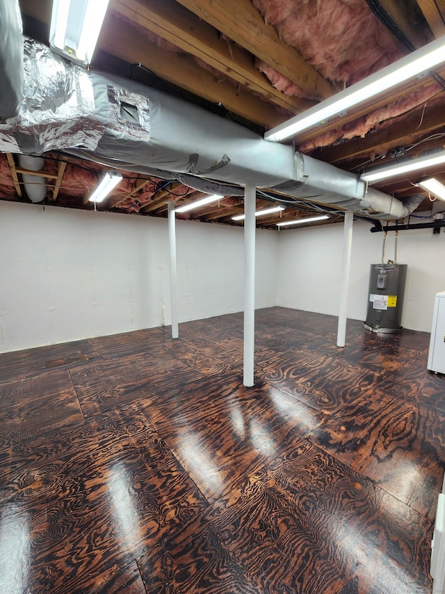 basement featuring washer / clothes dryer and water heater