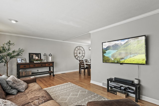 living room with hardwood / wood-style flooring and ornamental molding