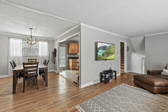 living room with crown molding and light wood-type flooring