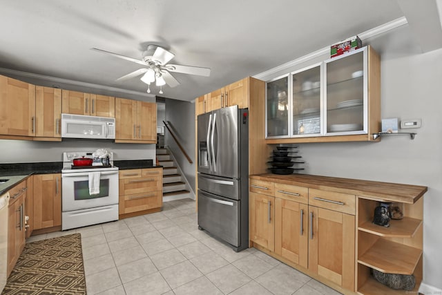 kitchen featuring ceiling fan, white appliances, ornamental molding, and light tile patterned floors