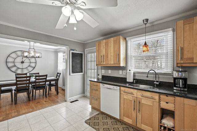 kitchen with sink, light tile patterned floors, white dishwasher, and decorative light fixtures