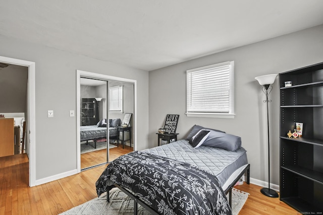 bedroom featuring hardwood / wood-style floors and a closet