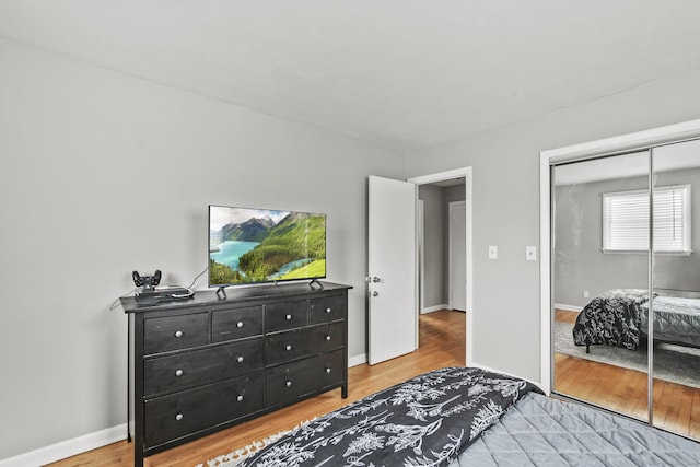 bedroom featuring light wood-type flooring and a closet