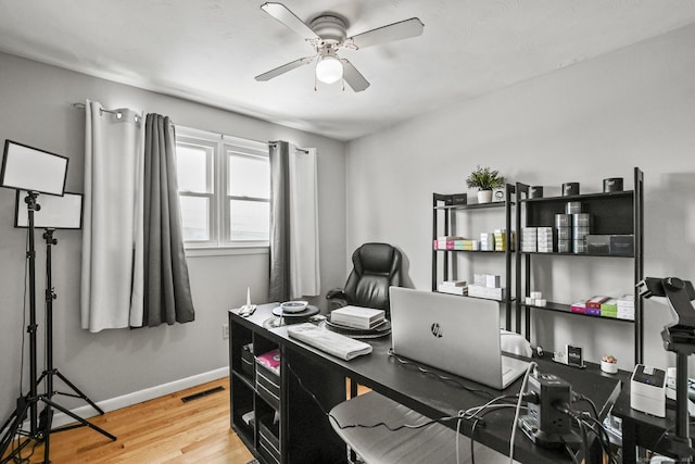 office with ceiling fan and light hardwood / wood-style flooring