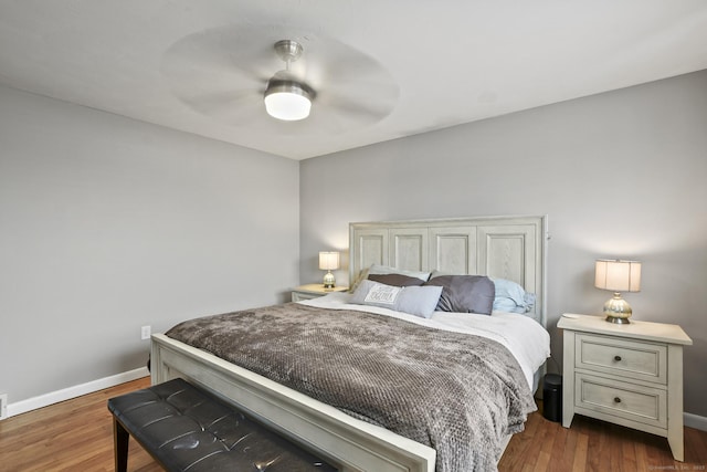 bedroom with dark hardwood / wood-style floors and ceiling fan