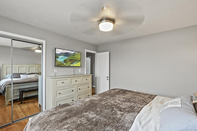 bedroom with light hardwood / wood-style floors, a closet, and ceiling fan