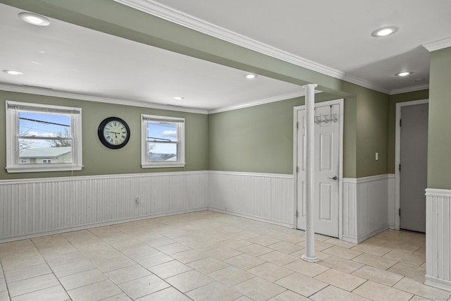 spare room with ornamental molding and light tile patterned floors