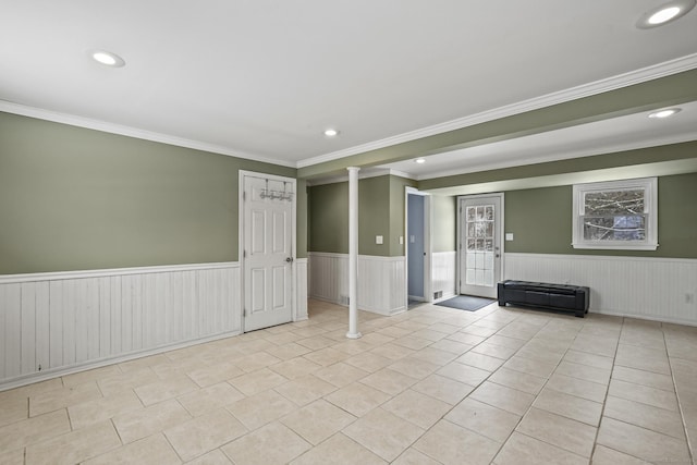 spare room with ornamental molding and light tile patterned floors