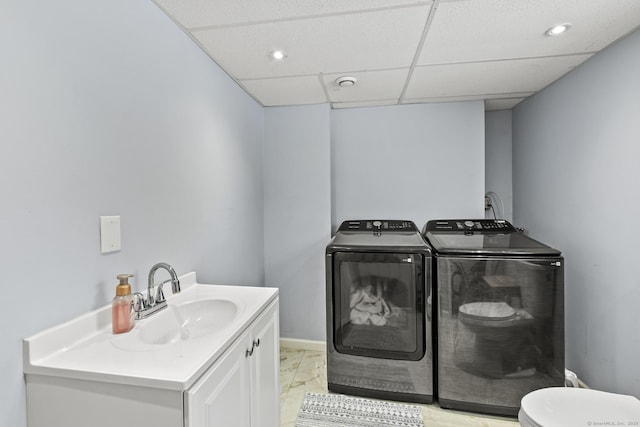 clothes washing area with sink and washer and clothes dryer