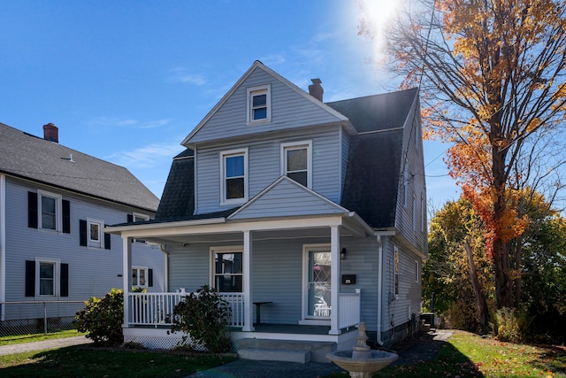 view of property with cooling unit and a porch