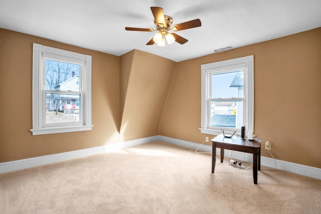 empty room featuring light carpet and ceiling fan