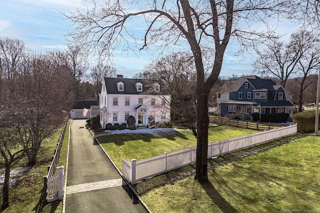 cape cod home featuring a front yard