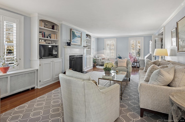 living room with crown molding, dark wood-type flooring, and radiator heating unit