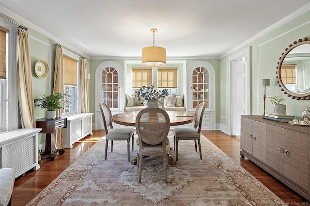 dining space featuring dark hardwood / wood-style flooring, radiator heating unit, and ornamental molding