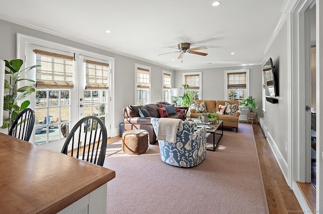 living room with hardwood / wood-style flooring, ceiling fan, ornamental molding, and french doors