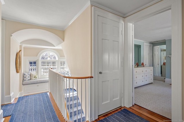 hallway featuring ornamental molding and wood-type flooring