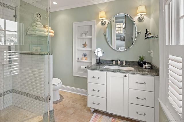 bathroom featuring tile patterned flooring, vanity, ornamental molding, toilet, and walk in shower