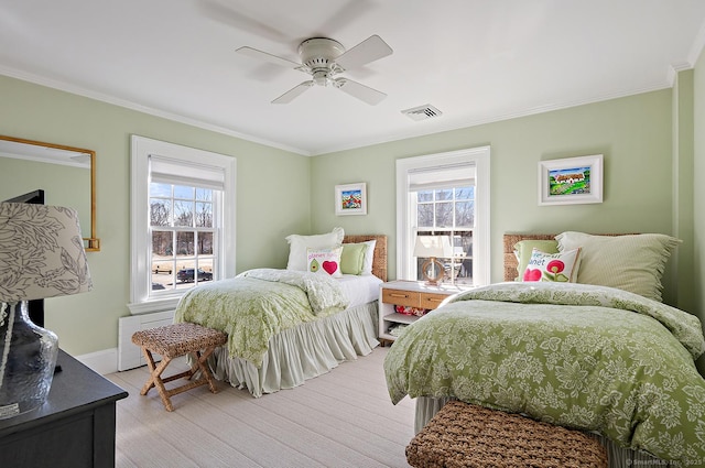 bedroom with multiple windows, crown molding, and ceiling fan