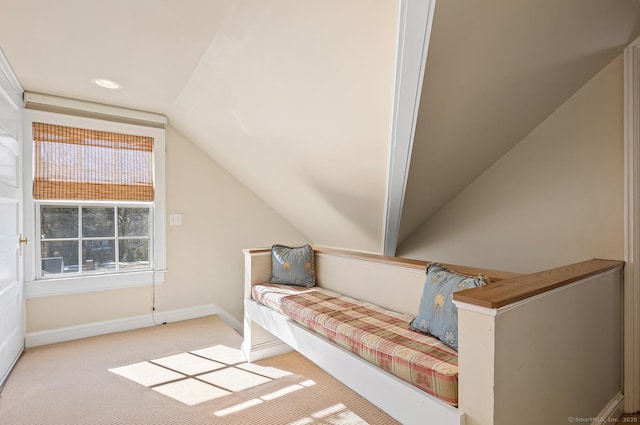 unfurnished bedroom with light carpet and lofted ceiling