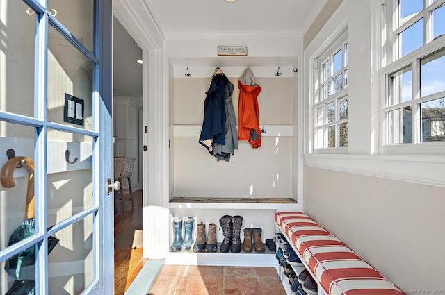 mudroom featuring tile patterned floors and ornamental molding