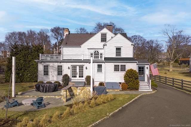 view of front of property with a balcony and a patio area