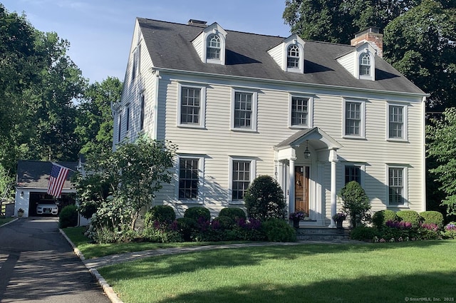 view of front of house with a garage and a front yard