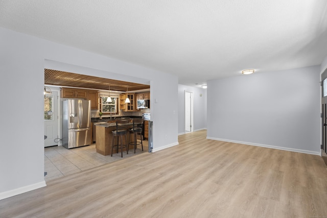 living room with light hardwood / wood-style floors and a textured ceiling