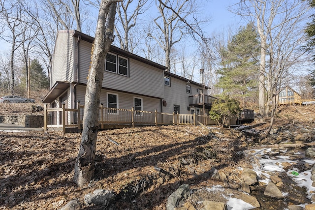 back of property with a wooden deck