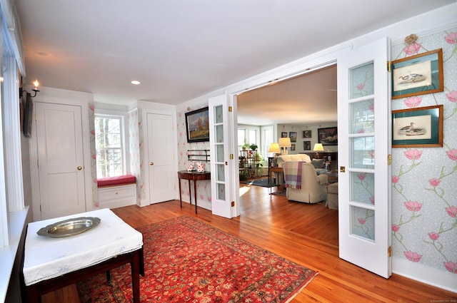 interior space with hardwood / wood-style floors, a wealth of natural light, and french doors