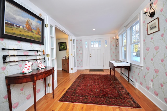 entryway featuring a baseboard heating unit and light wood-type flooring