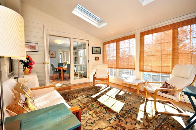 sunroom with french doors and lofted ceiling with skylight